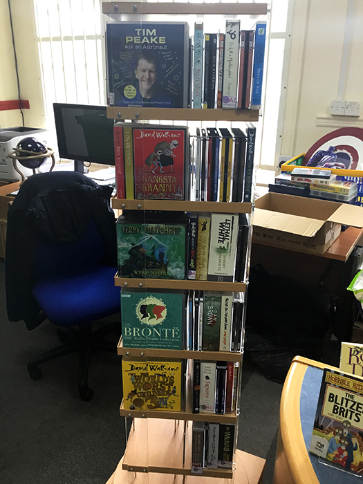 Another angle of a bookshelf holding the audiobooks donated to QAC in the college library